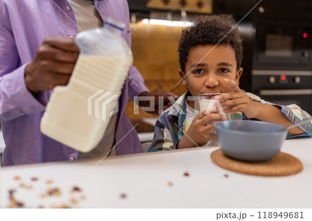 Father and kids having breakfast together in the kitchen Father and kids having breakfast together in the kitchen 118949681