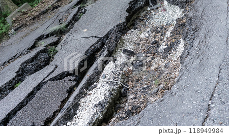 Cracks on an asphalt road close-up, destruction as a result of a mudflow 118949984