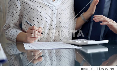 Businesspeople in a meeting with calculator. Sexual harassment is strictly prohibited in the workplace Businesspeople in a meeting with calculator. Sexual harassment is strictly prohibited in the workplace 118950146