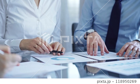 Business people are reviewing a financial results and discussing the terms of the agreement. Teamwork and planning 118950269