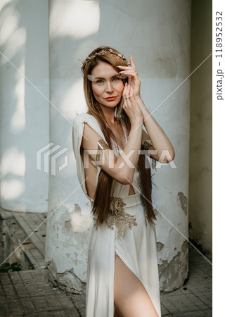 Two beautiful girls, sisters Lilith and Eva, pose in rocking dresses against the background of columns. 118952532