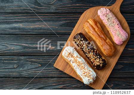 Assorted eclairs on a pastel top view Traditional French dessert Assorted eclairs on a pastel top view Traditional French dessert 118952637