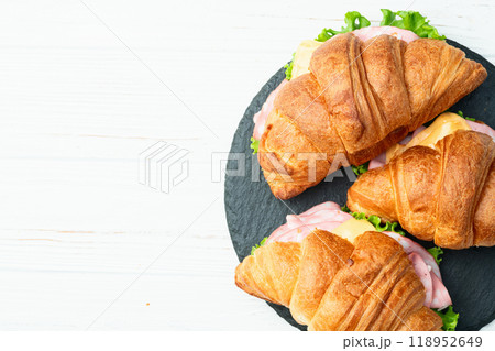 Croissant sandwich with salad ham and cheese . Top view Croissant sandwich with salad ham and cheese . Top view 118952649