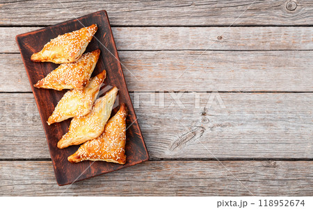 Homemade triangle puff pastry with meat on rustic background . Samosa Homemade triangle puff pastry with meat on rustic background . Samosa 118952674