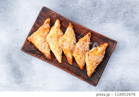 Homemade triangle puff pastry with meat on rustic background . Samosa Homemade triangle puff pastry with meat on rustic background . Samosa 118952676