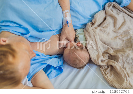 A mom breastfeeds her newborn baby in the hospital. The intimate moment fosters bonding between mother and child, promoting emotional connection and providing essential nourishment for the baby's well 118952762