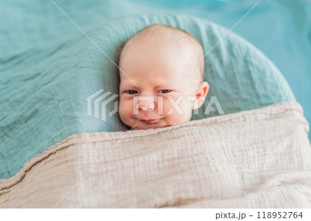 The baby is sleeping peacefully in his cozy nest. Newborn photo session captures the serene innocence and warmth of early moments 118952764