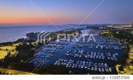 Burnham Harbor on Lake Michigan boats at night with sunset lighting and city lights, Chicago aerial Burnham Harbor on Lake Michigan boats at night with sunset lighting and city lights, Chicago aerial 118953560