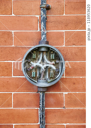 Aged Electrical Junction Box on Brick Wall, Eye-Level View 118953620