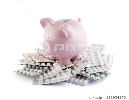Pink piggy bank on heap of many various pills and tablets packs for savings and healthcare concept 118954370