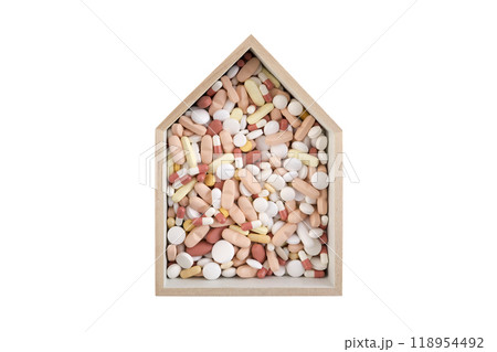 House with heap of medicine pills isolated on white background with clipping path 118954492