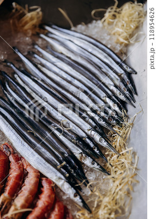 Fresh fish lined up on ice display at seafood market. Perfect for food photography, menus Fresh fish lined up on ice display at seafood market. Perfect for food photography, menus 118954626
