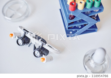 Top view of magnifying glasses with LED lights resting on laboratory table. Professional equipment for microbiology scientists to study microscopic organisms placed at chemists workstation, copy space 118954766