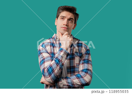 Thinking around man on blue background. Smart student 30s guy searching answer 118955035
