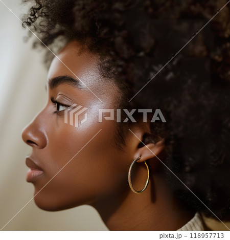 Close up of a woman ear showcasing elegant hoop earrings in soft lighting Close up of a woman ear showcasing elegant hoop earrings in soft lighting 118957713