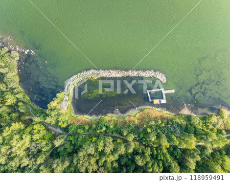 Aerial view of lake or river green shore with forest. Summer season. Aerial view of lake or river green shore with forest. Summer season. 118959491