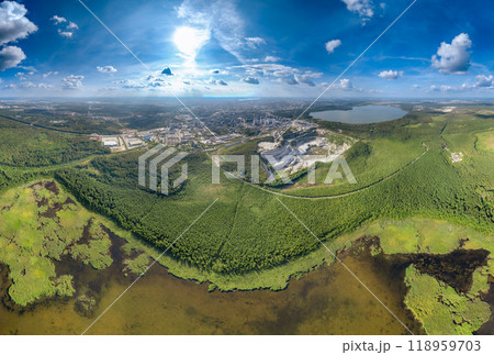 Big lake with green shores in bright sun light and city on horizon, aerial landscape. Recreation concept. Aerial view 118959703
