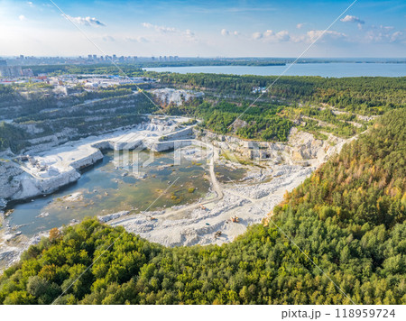 Stone quarry in the forest. Flying over the summer mixed forest during sunset. The surroundings of Yekaterinburg. Ural, Russia, Aerial View Stone quarry in the forest. Flying over the summer mixed forest during sunset. The surroundings of Yekaterinburg. Ural, Russia, Aerial View 118959724