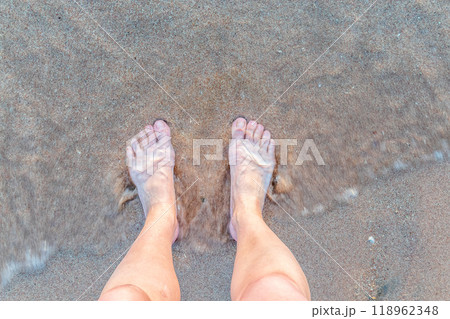 Beach - women's foot and the grains of sand. Beach - women's foot and the grains of sand. 118962348