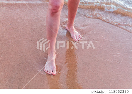 Beach - women's foot and the grains of sand. 118962350