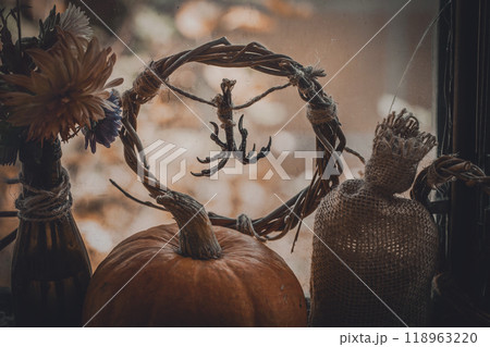Pagan home autumn altar. Dry birds claws, pumpkin, willow wreath, flowers and canvas bag as a set. Pagan home autumn altar. Dry birds claws, pumpkin, willow wreath, flowers and canvas bag as a set. 118963220