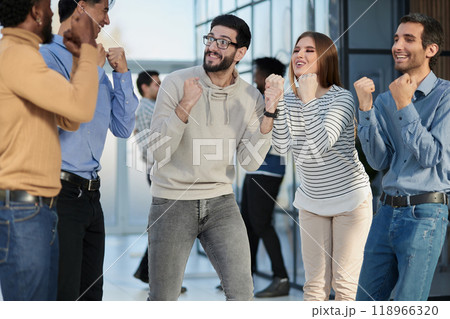 Business people celebrates and clench their fists in the air as a winning team Business people celebrates and clench their fists in the air as a winning team 118966320