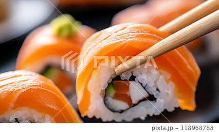 Sushi roll with fresh salmon, rice, and chopsticks Sushi roll with fresh salmon, rice, and chopsticks 118968788