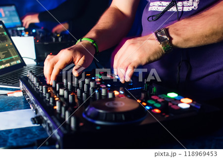 hands of DJs playing on professional Board and mixer with laptop hands of DJs playing on professional Board and mixer with laptop 118969453