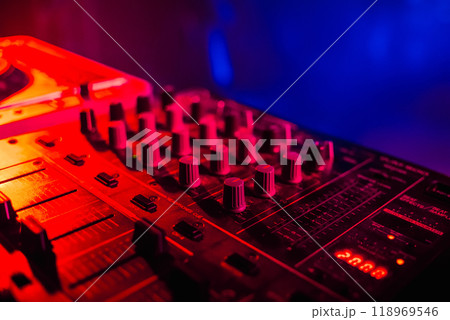 music dj panel mixer in a booth at a nightclub 118969546
