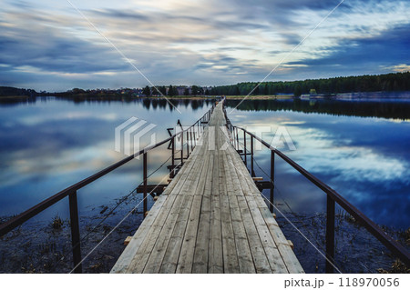 old wooden bridge over triver in evening in summer old wooden bridge over triver in evening in summer 118970056