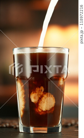 Pouring Milk into Coffee Drink in Detail. 118972216