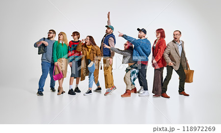 Group of people, men and women wearing stylish autumn outfits, showing their readiness and excitement to get best shopping deals Group of people, men and women wearing stylish autumn outfits, showing their readiness and excitement to get best shopping deals 118972269