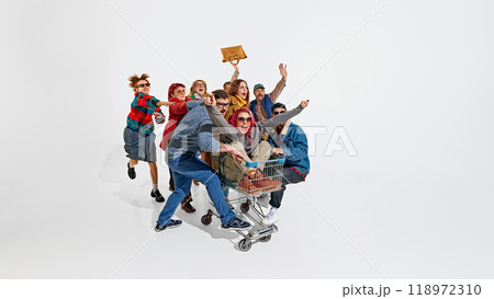 Group of emotional people, men in women pushing forward the best shopping deals, pushing shopping cart. Intensity of shopping activity 118972310