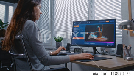 Adult woman enters prompt in AI chatbot on personal computer 118973175