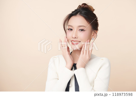 Beautiful young asian woman with clean fresh skin on beige background, Face care, Facial treatment, Cosmetology, beauty and spa, Asian women portrait. Beautiful young asian woman with clean fresh skin on beige background, Face care, Facial treatment, Cosmetology, beauty and spa, Asian women portrait. 118973598