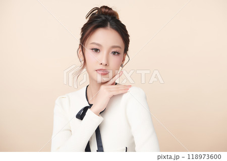 Beautiful young asian woman with clean fresh skin on beige background, Face care, Facial treatment, Cosmetology, beauty and spa, Asian women portrait. Beautiful young asian woman with clean fresh skin on beige background, Face care, Facial treatment, Cosmetology, beauty and spa, Asian women portrait. 118973600