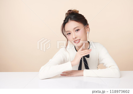 Beautiful young asian woman with clean fresh skin on beige background, Face care, Facial treatment, Cosmetology, beauty and spa, Asian women portrait. Beautiful young asian woman with clean fresh skin on beige background, Face care, Facial treatment, Cosmetology, beauty and spa, Asian women portrait. 118973602