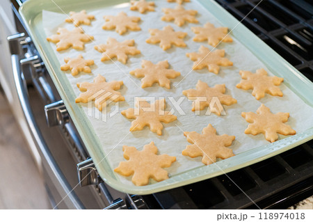 Letting delightful snowflake-shaped sugar cookies cool after baking, preparing them for festive Christmas gifts. Letting delightful snowflake-shaped sugar cookies cool after baking, preparing them for festive Christmas gifts. 118974018