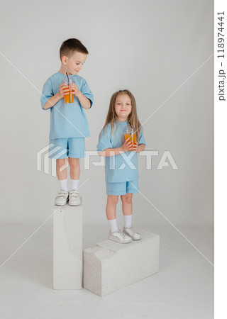 Two young children have fun in the studio on an white background. Two young children have fun in the studio on an white background. 118974441