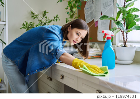 Young woman cleaning room, dusting, cleaning with spray and cloth Young woman cleaning room, dusting, cleaning with spray and cloth 118974531