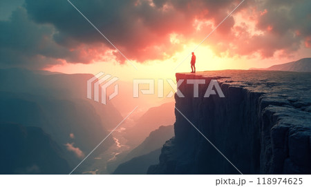 Lone explorer on mountain cliff during golden hour, vast wilderness view, serene sunset over rugged peaks, inspirational solo journey backdrop, dramatic outdoor adventure setting in wilderness 118974625
