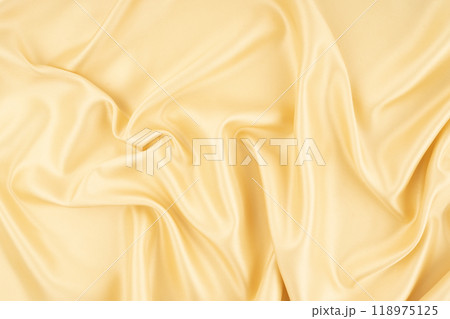 Close-up shot of gold satin texture background. Close-up shot of gold satin texture background. 118975125