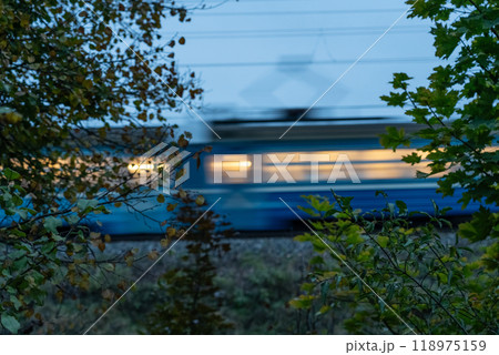 The electric train goes fast in the evening. Long exposure, lubrication The electric train goes fast in the evening. Long exposure, lubrication 118975159