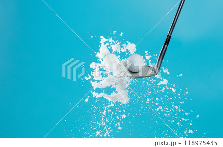 Golf Ball golfer hit snow to explode and splatter. Sand wedge golf dick ball from snow field and snow fly in air. Blue sky background isolated Golf Ball golfer hit snow to explode and splatter. Sand wedge golf dick ball from snow field and snow fly in air. Blue sky background isolated 118975435