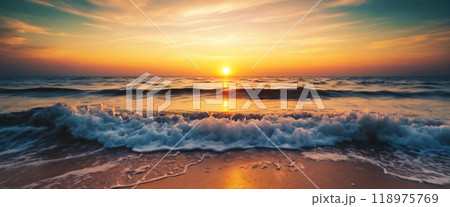 Waves crashing on the shore at sunset with golden light 118975769