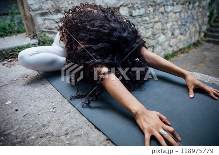 brunette woman doing yoga asana outdoor gymnastics brunette woman doing yoga asana outdoor gymnastics 118975779