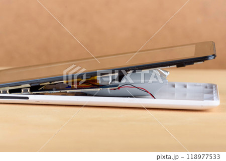 Damaged smartphone showing internal components and battery. 118977533