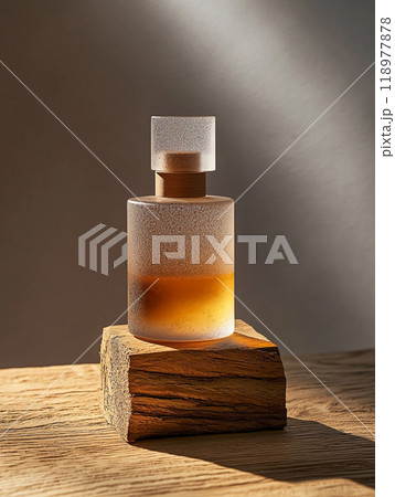 A frosted glass bottle perfume, placed on a piece of oak base. Sandblasted surface. A frosted glass bottle perfume, placed on a piece of oak base. Sandblasted surface. 118977878