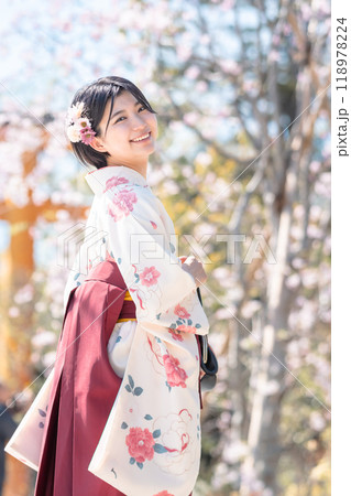 さくら咲く街を袴姿で歩く若い女性 118978224