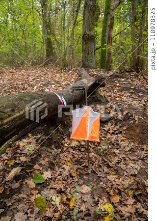 Orienteering. Control point Prism and electric composter for orienteering in the spring forest. Orienteering. Control point Prism and electric composter for orienteering in the spring forest. 118978325